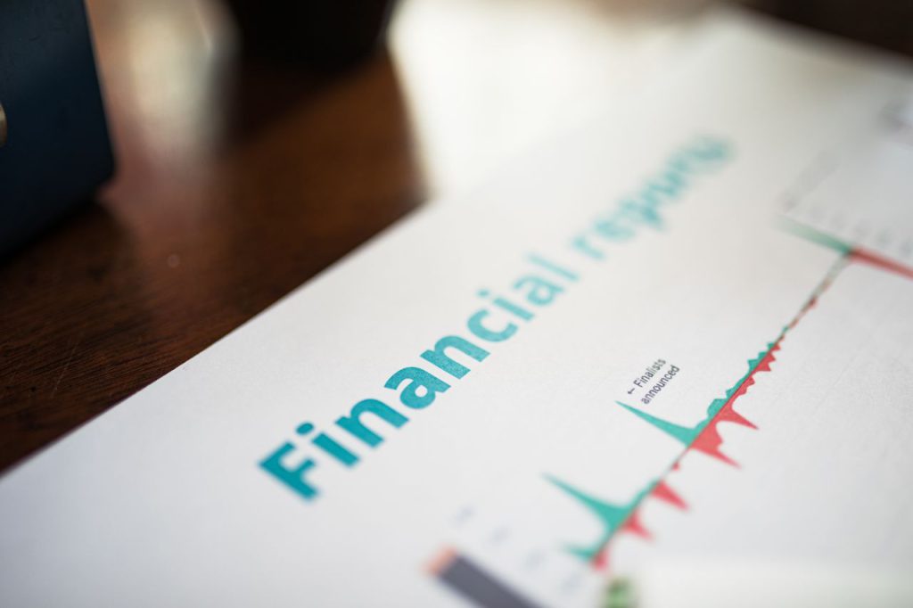 A printed financial report featuring data charts and economic performance metrics, used for analyzing market trends.